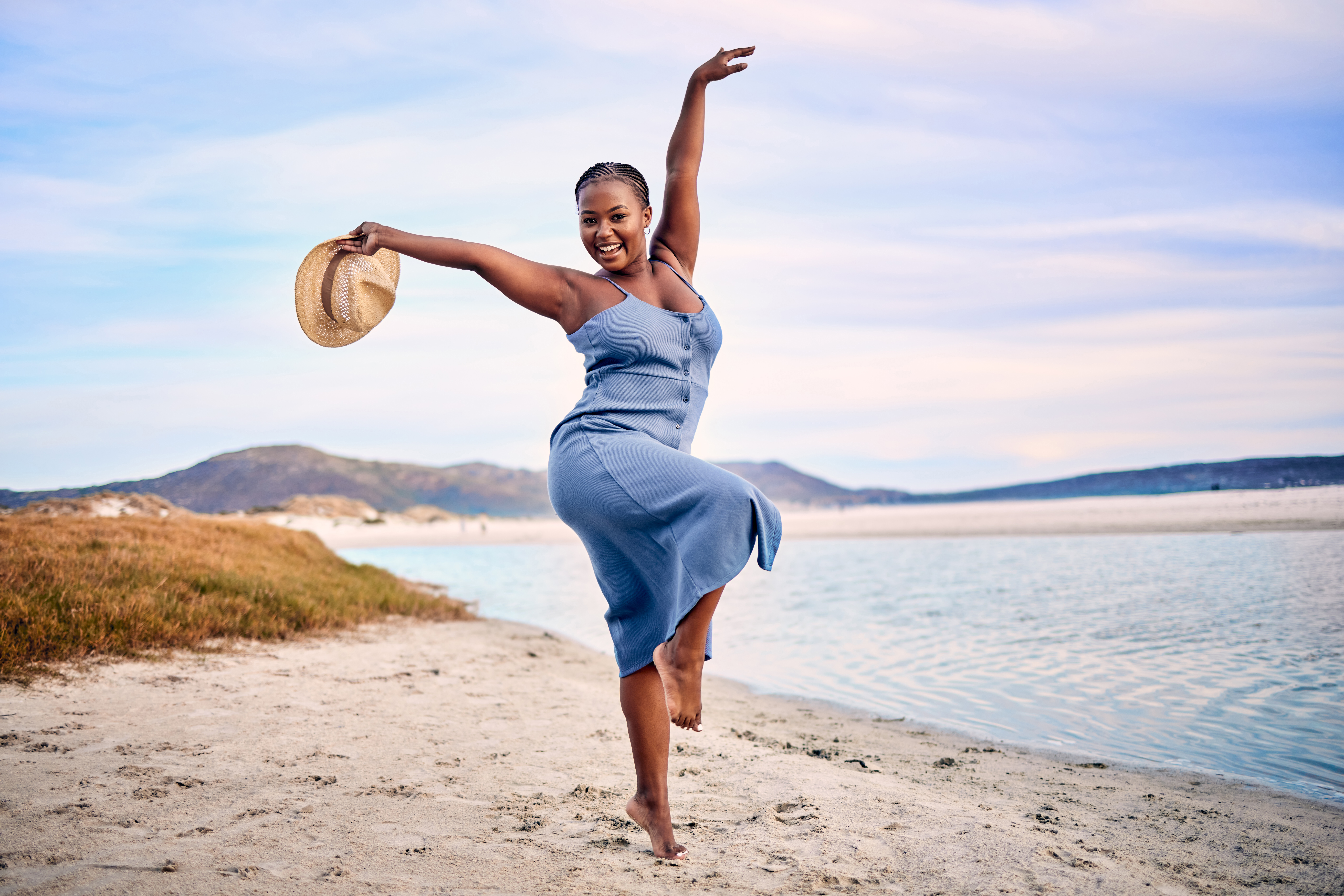 Portrait of an ecstatic young woman enjoying her time at the beach
